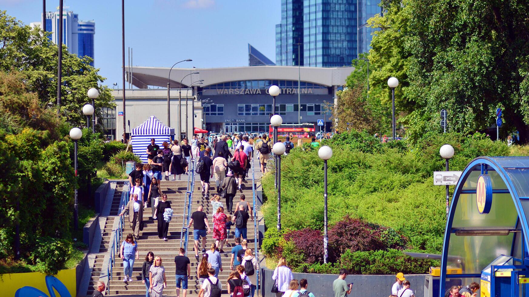 Warsaw, Poland. 8 June 2024. Crowd of people on Patelnia square in centrum city. The colloquial name. An important communication point on the city map with residents, tourists and buildings. photo