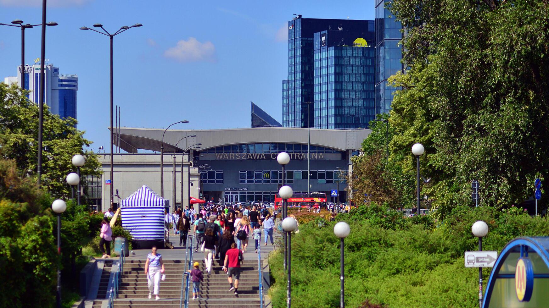 Warsaw, Poland. 8 June 2024. Crowd of people on Patelnia square in centrum city. The colloquial name. An important communication point on the city map with residents, tourists and buildings. photo