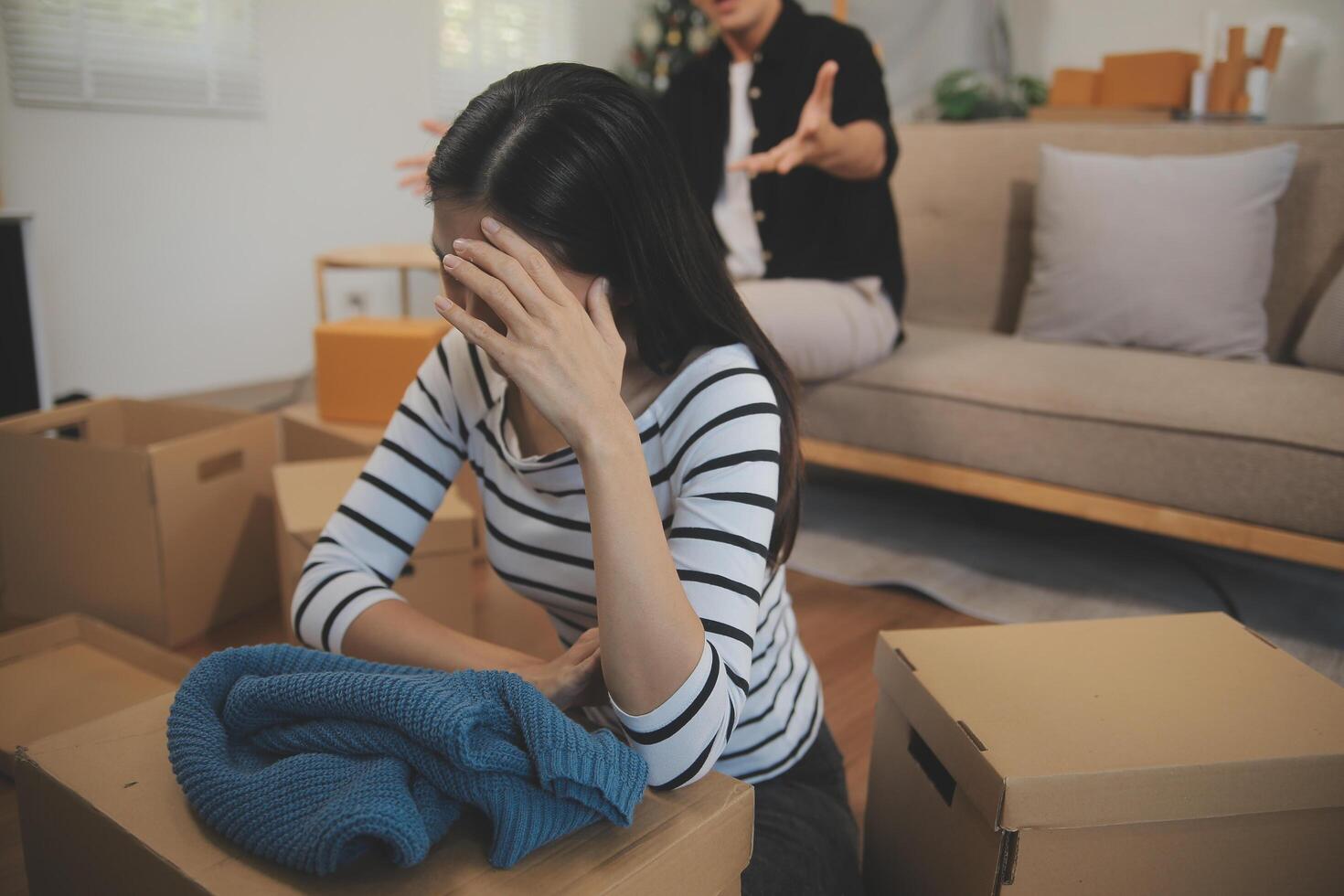 Two Asian blogger showing clothes in front of the camera to recording vlog live streaming at her shop. Online Shopping Cart notion. on sofa at home photo