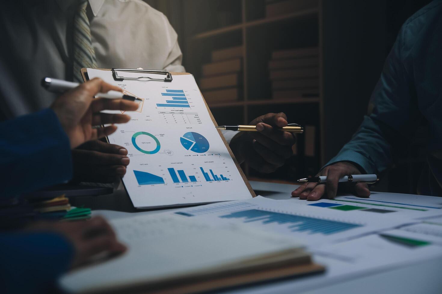 Business team meeting present, investor colleagues consultation and conference new strategy plan business and market growth on financial document graph report, Meeting and Talking. photo