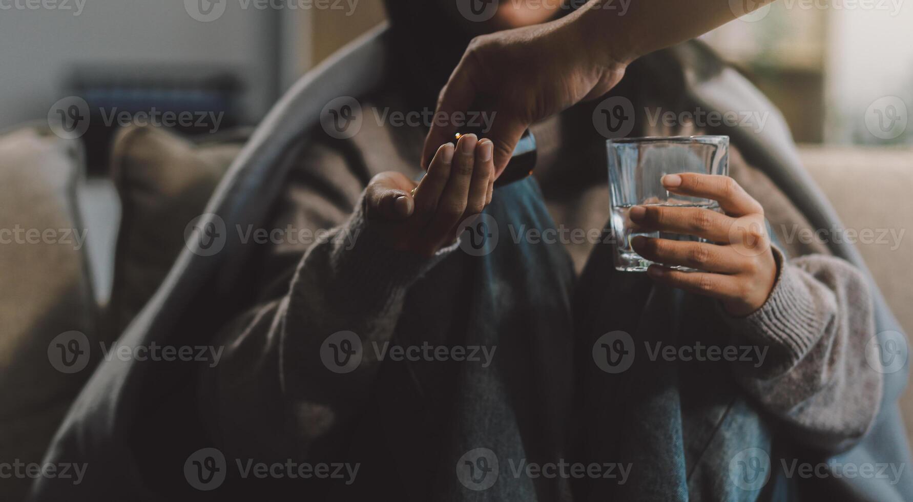 Upset woman frustrated by problem with work or relationships, sitting on couch, embracing knees, covered face in hand, feeling despair and anxiety, loneliness, having psychological trouble photo