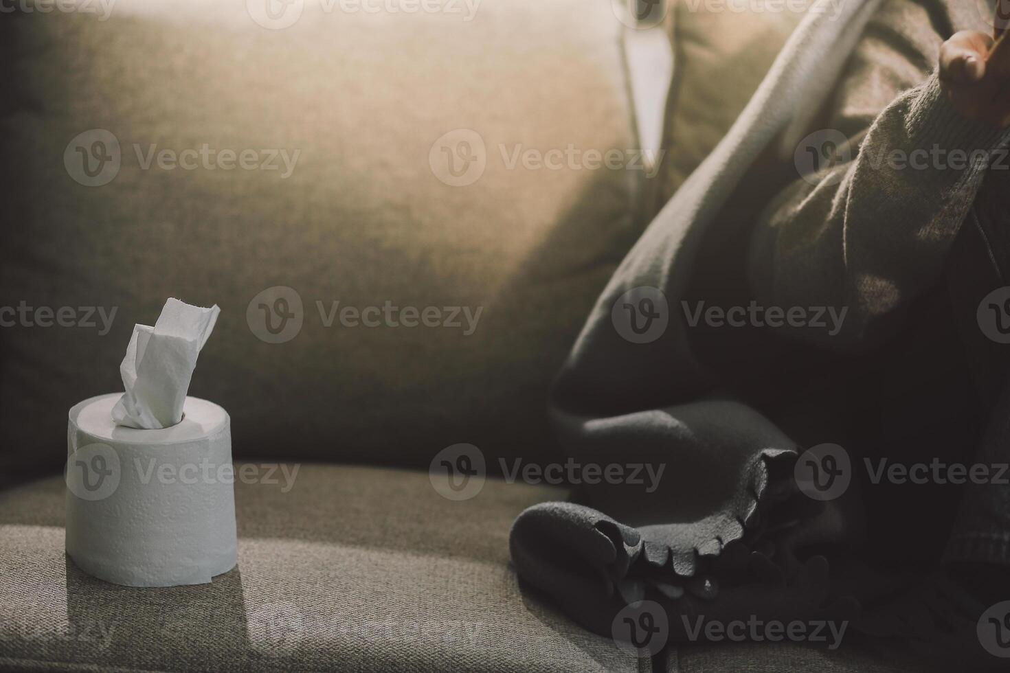 Upset woman frustrated by problem with work or relationships, sitting on couch, embracing knees, covered face in hand, feeling despair and anxiety, loneliness, having psychological trouble photo