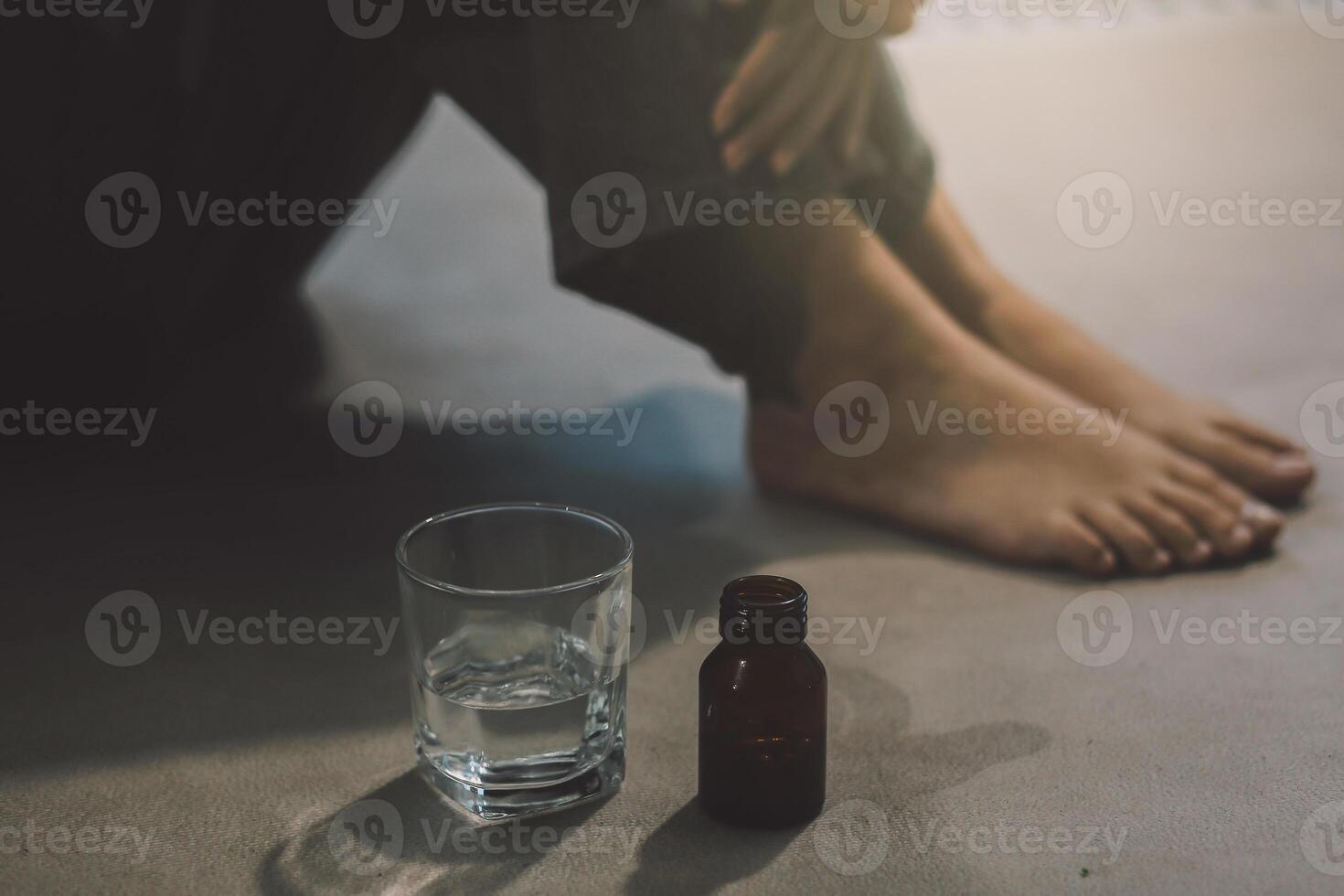 Upset woman frustrated by problem with work or relationships, sitting on couch, embracing knees, covered face in hand, feeling despair and anxiety, loneliness, having psychological trouble photo
