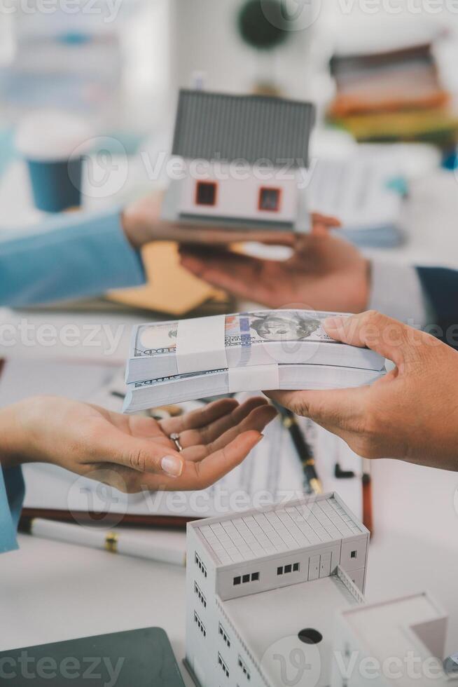 Real estate agent talked about the terms of the home purchase agreement and asked the customer to sign the documents to make the contract legally, Home sales and home insurance concept. photo