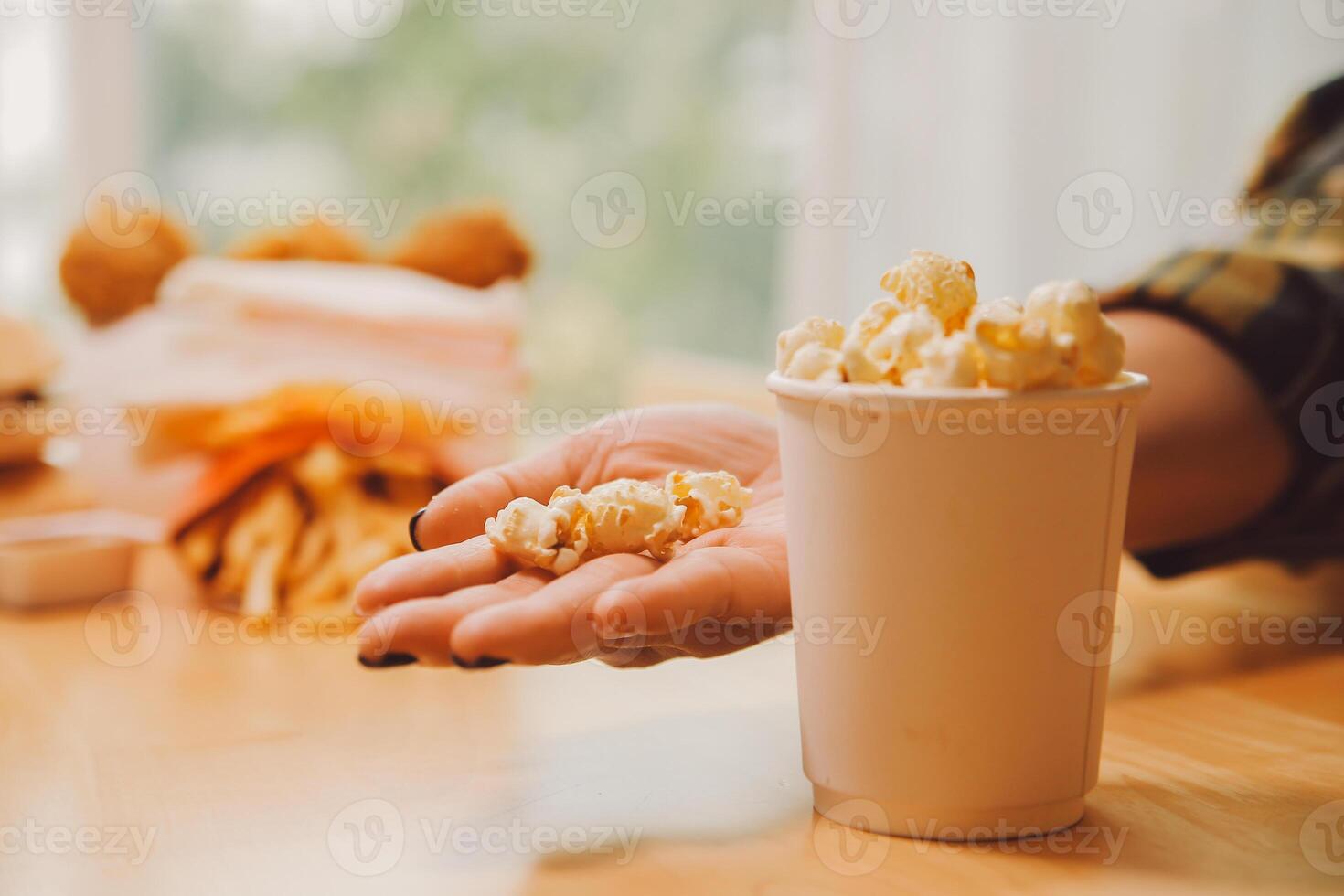 A woman holding a bowl of popcorn photo