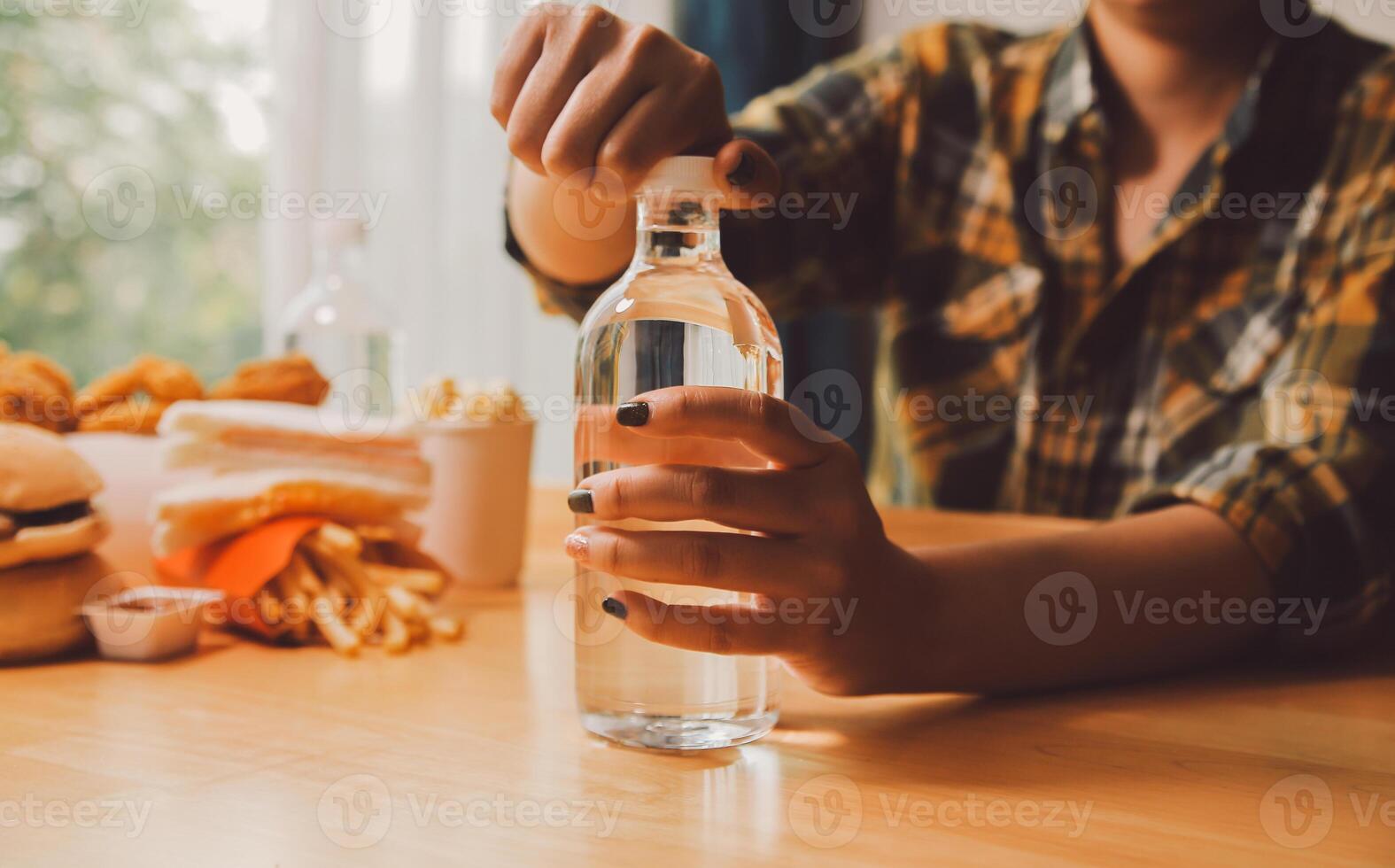 healthy beautiful young woman holding glass of water photo