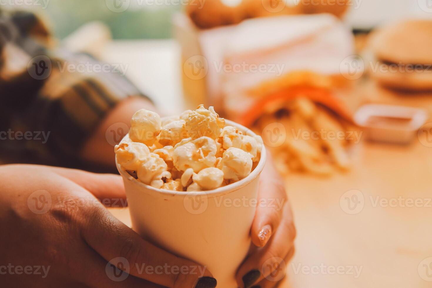 A woman holding a bowl of popcorn photo