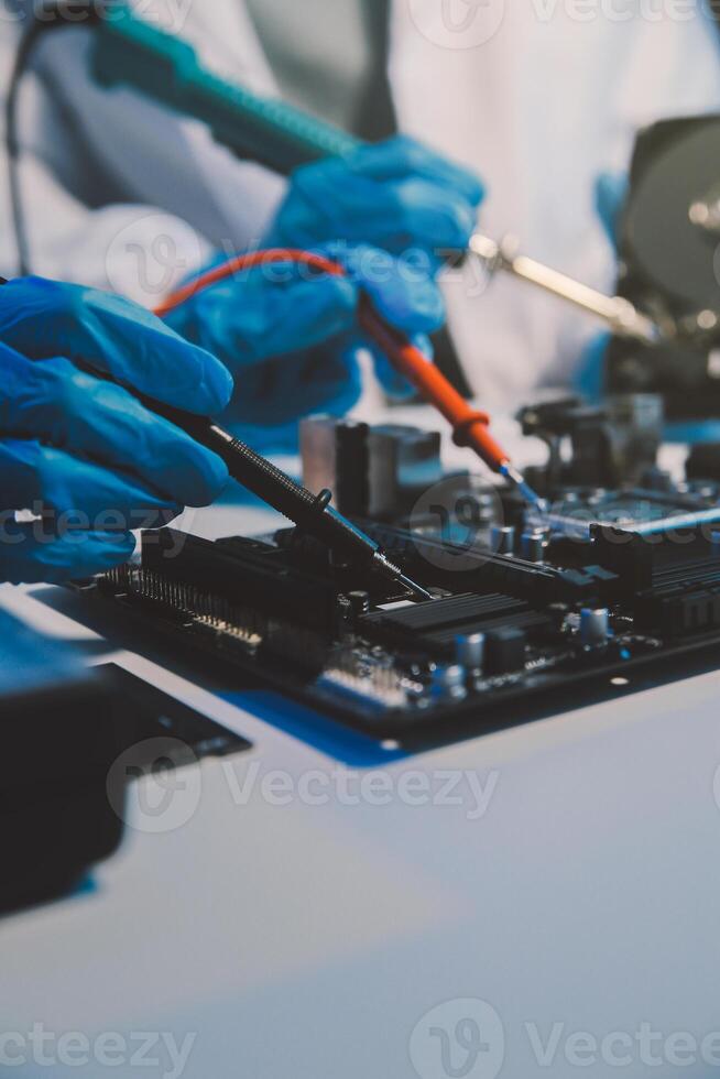 Close up of Technician measuring voltage electronic circuit board television, Service after sale fix electric equipment within insurance. photo