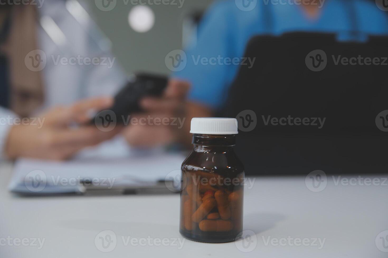 Asian psychologist women pointing on pills bottle to explaining medicine and prescription to female patient while giving counseling about medical and mental health therapy to female patient in clinic. photo