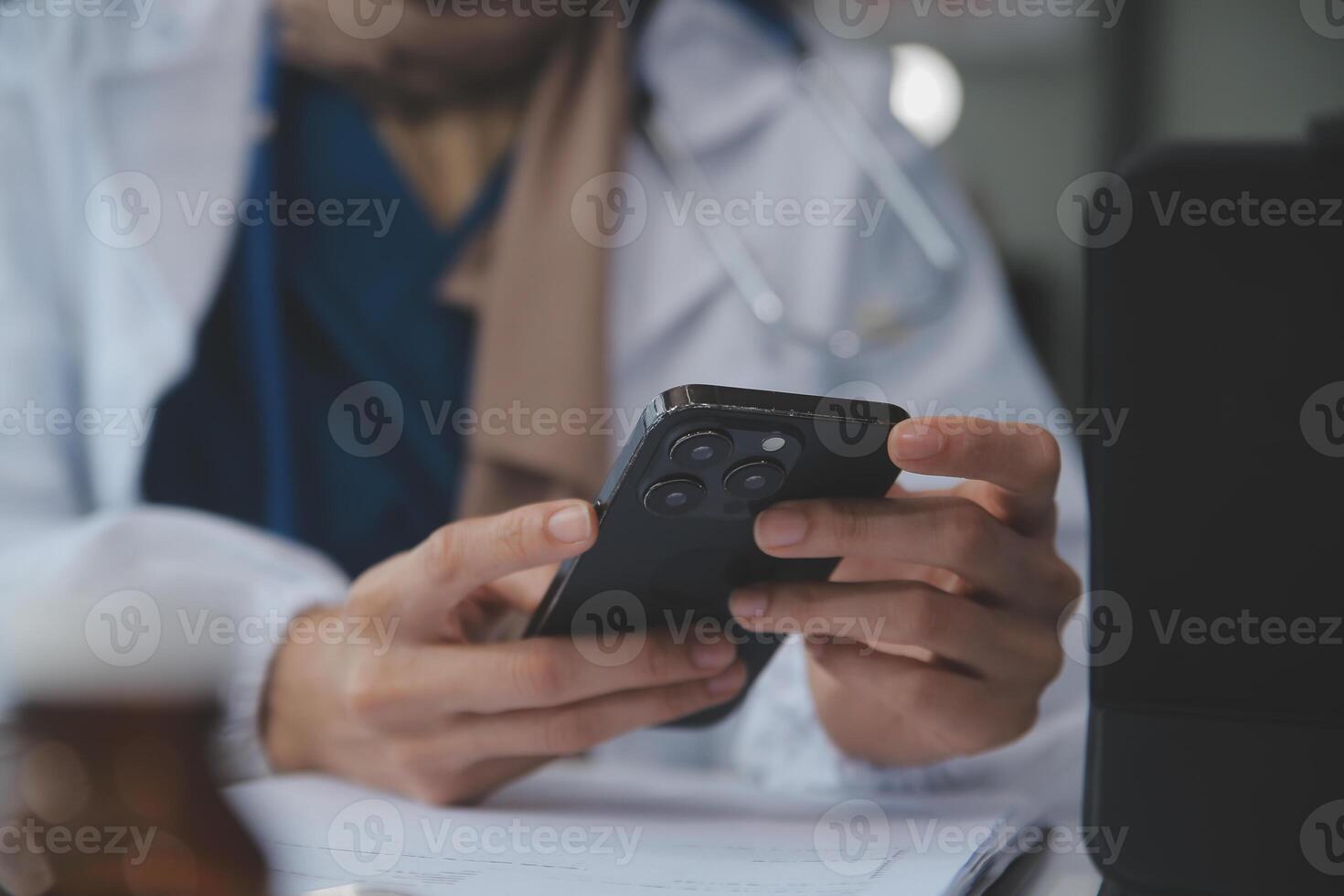 Consultation Online. Unrecognizable doctor using smartphone at workplace, messaging with patient, prescribing treatment photo