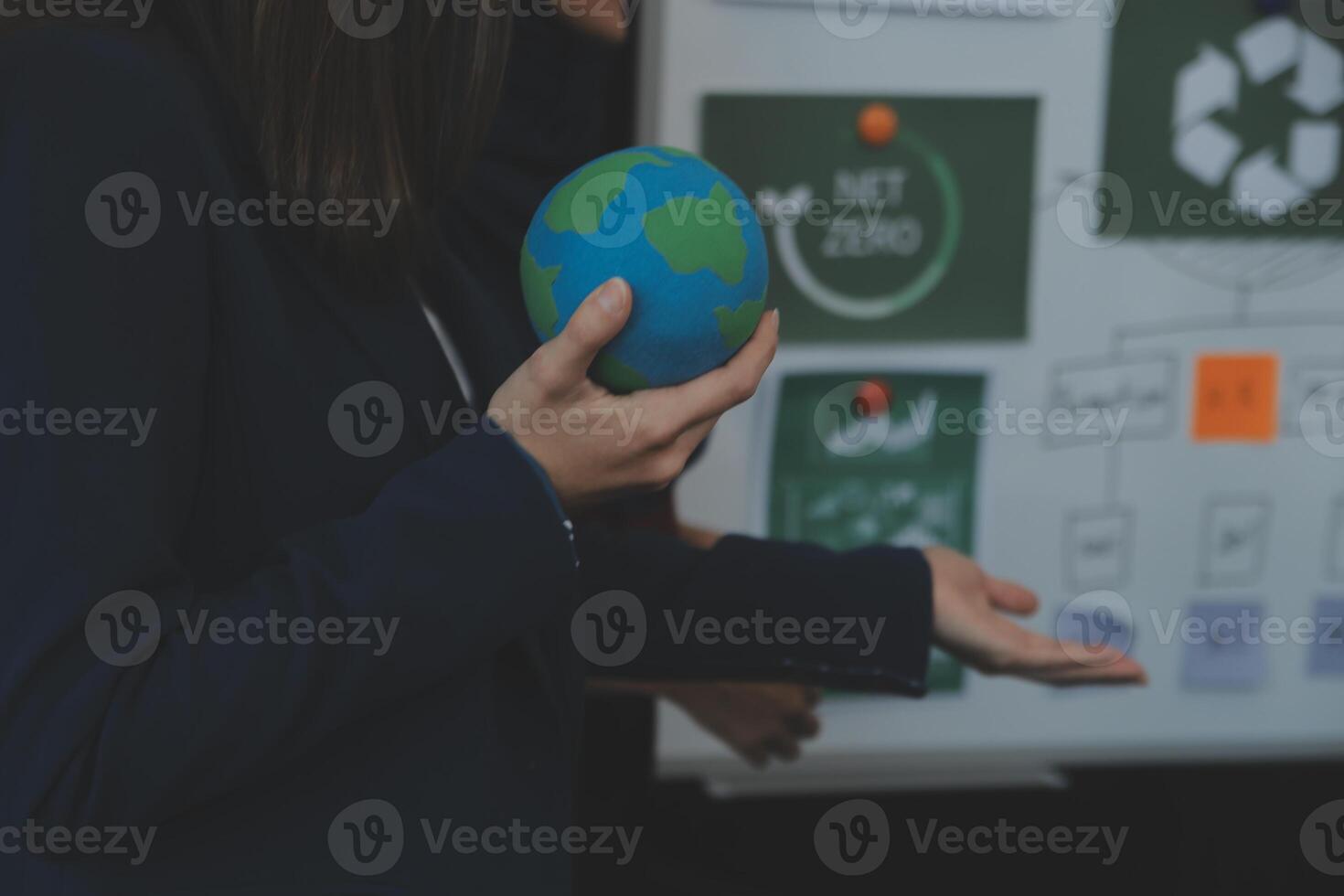 Business people having consultation about wind energy at company office. Business team discussing about windmill and alternative green energy. Executive meeting at modern office photo