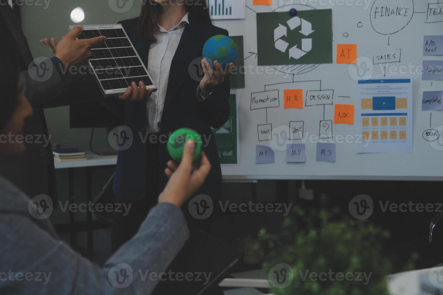 Business people having consultation about wind energy at company office. Business team discussing about windmill and alternative green energy. Executive meeting at modern office photo