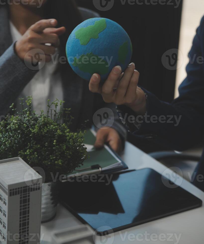 Business people having consultation about wind energy at company office. Business team discussing about windmill and alternative green energy. Executive meeting at modern office photo