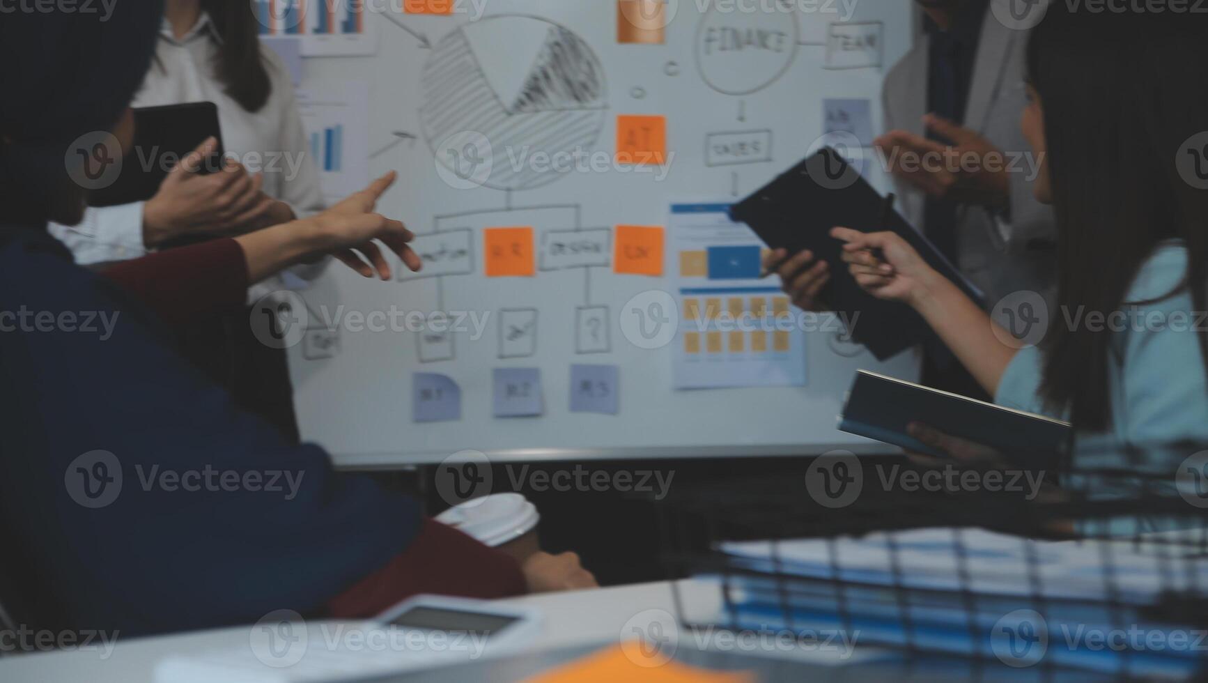 Financial analysts analyze business financial reports on a digital tablet planning investment project during a discussion at a meeting of corporate showing the results of their successful teamwork. photo