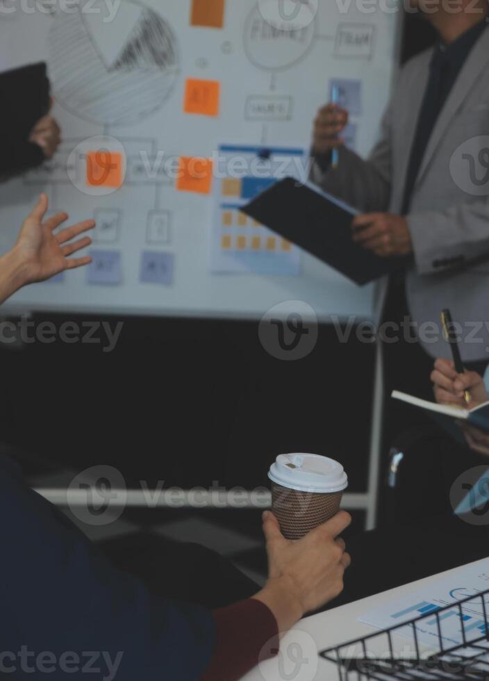 Financial analysts analyze business financial reports on a digital tablet planning investment project during a discussion at a meeting of corporate showing the results of their successful teamwork. photo