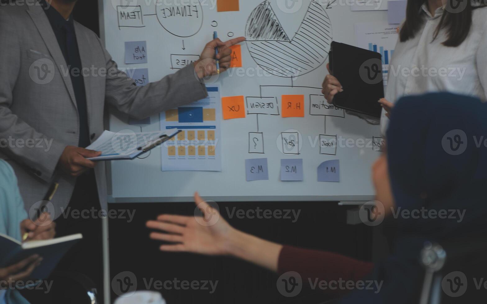 Financial analysts analyze business financial reports on a digital tablet planning investment project during a discussion at a meeting of corporate showing the results of their successful teamwork. photo