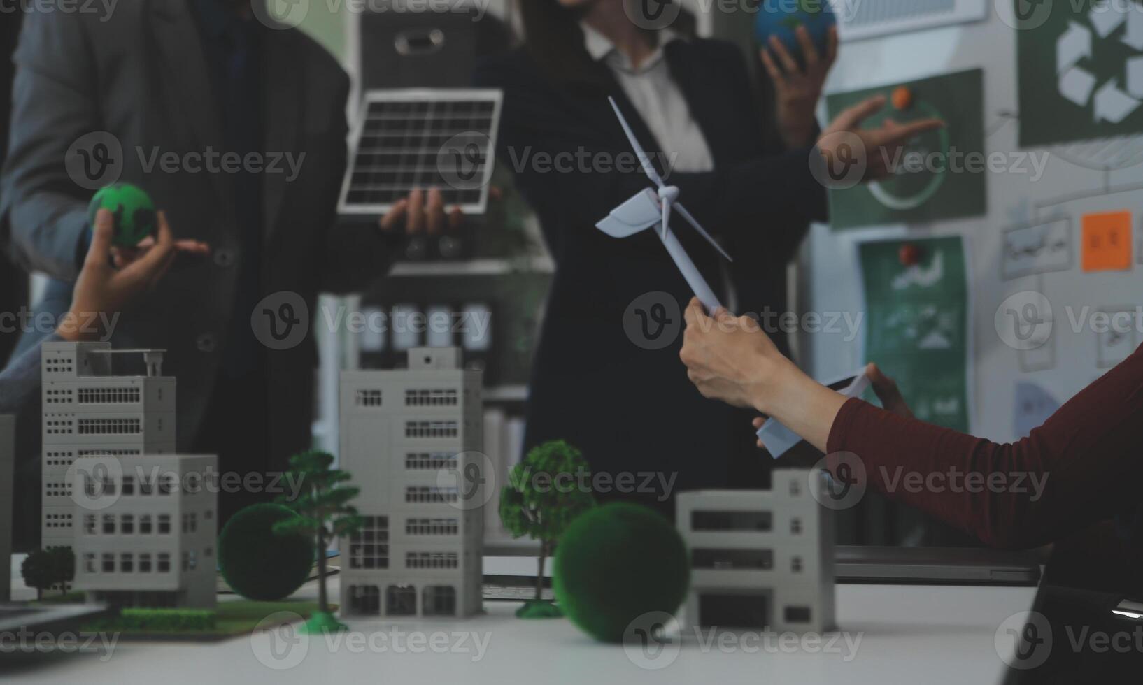 Business people having consultation about wind energy at company office. Business team discussing about windmill and alternative green energy. Executive meeting at modern office photo