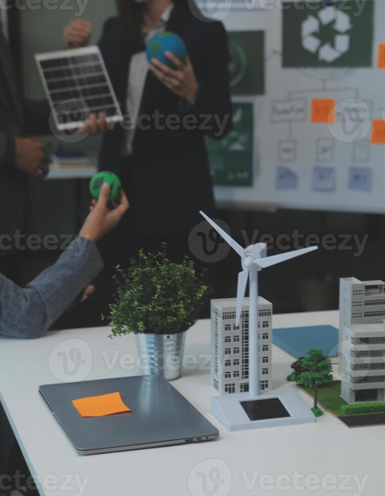 Business people having consultation about wind energy at company office. Business team discussing about windmill and alternative green energy. Executive meeting at modern office photo