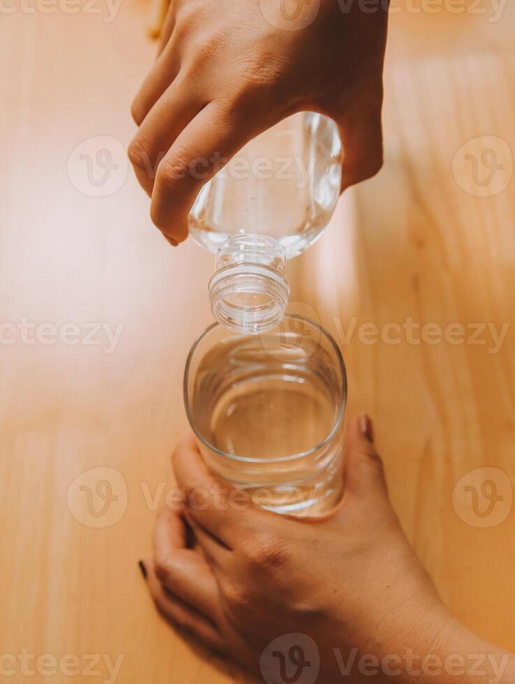 healthy beautiful young woman holding glass of water photo