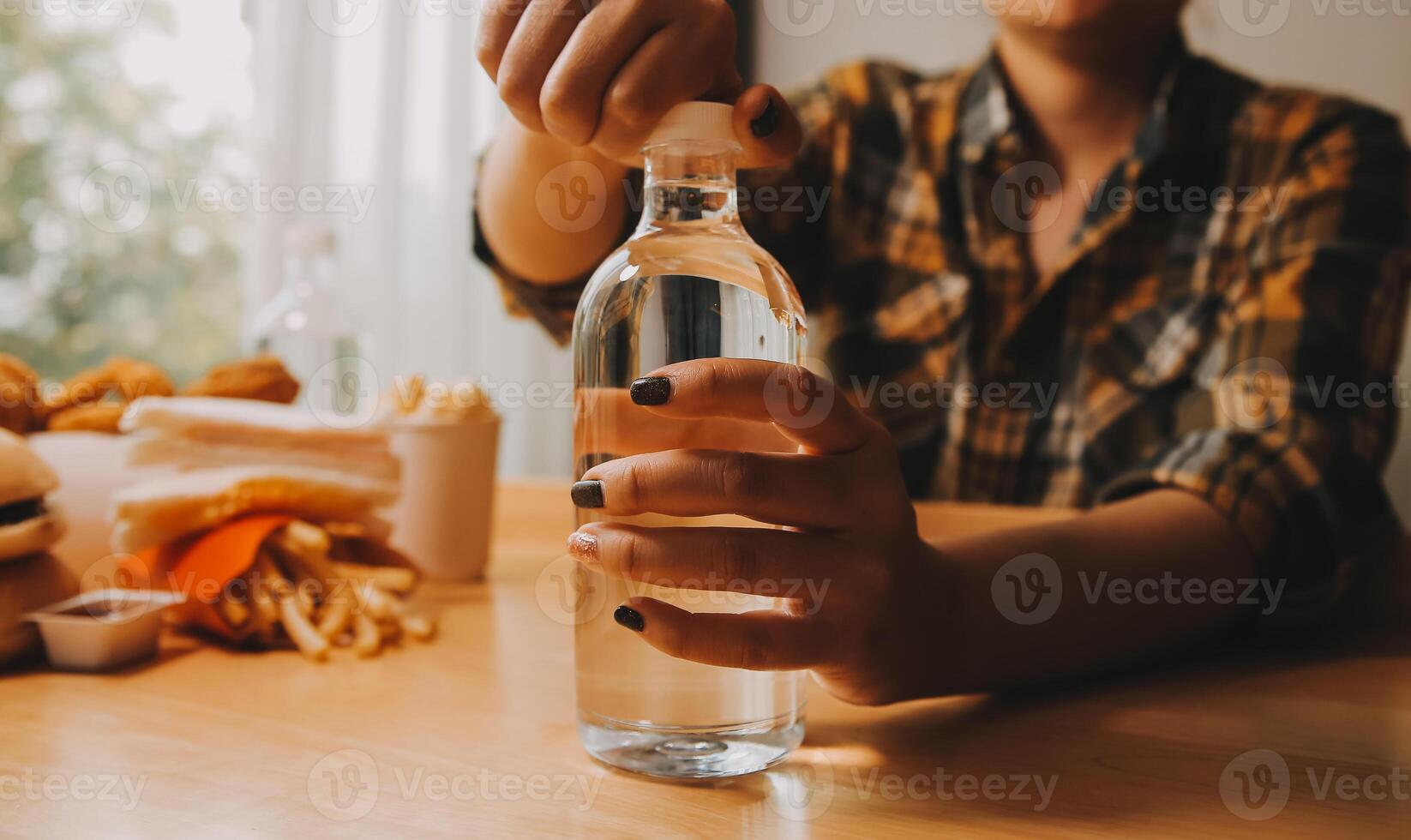 healthy beautiful young woman holding glass of water photo