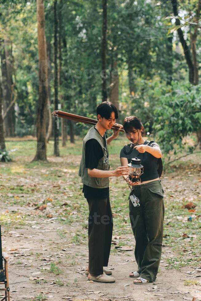 Asian couple sweet in tent inside on they camping trip, traveller relax and sleep togather in out door and camping trip photo