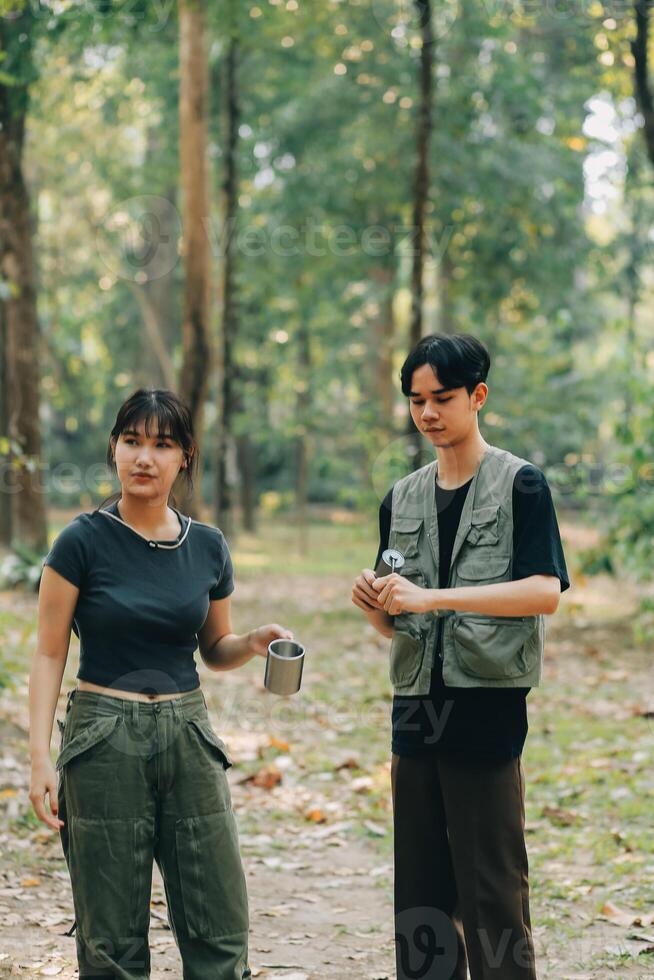 Asian couple sweet in tent inside on they camping trip, traveller relax and sleep togather in out door and camping trip photo