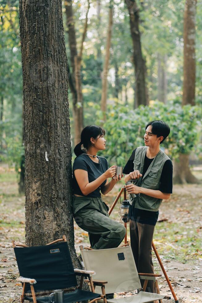 Asian couple sweet in tent inside on they camping trip, traveller relax and sleep togather in out door and camping trip photo