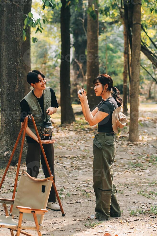 Asian couple sweet in tent inside on they camping trip, traveller relax and sleep togather in out door and camping trip photo