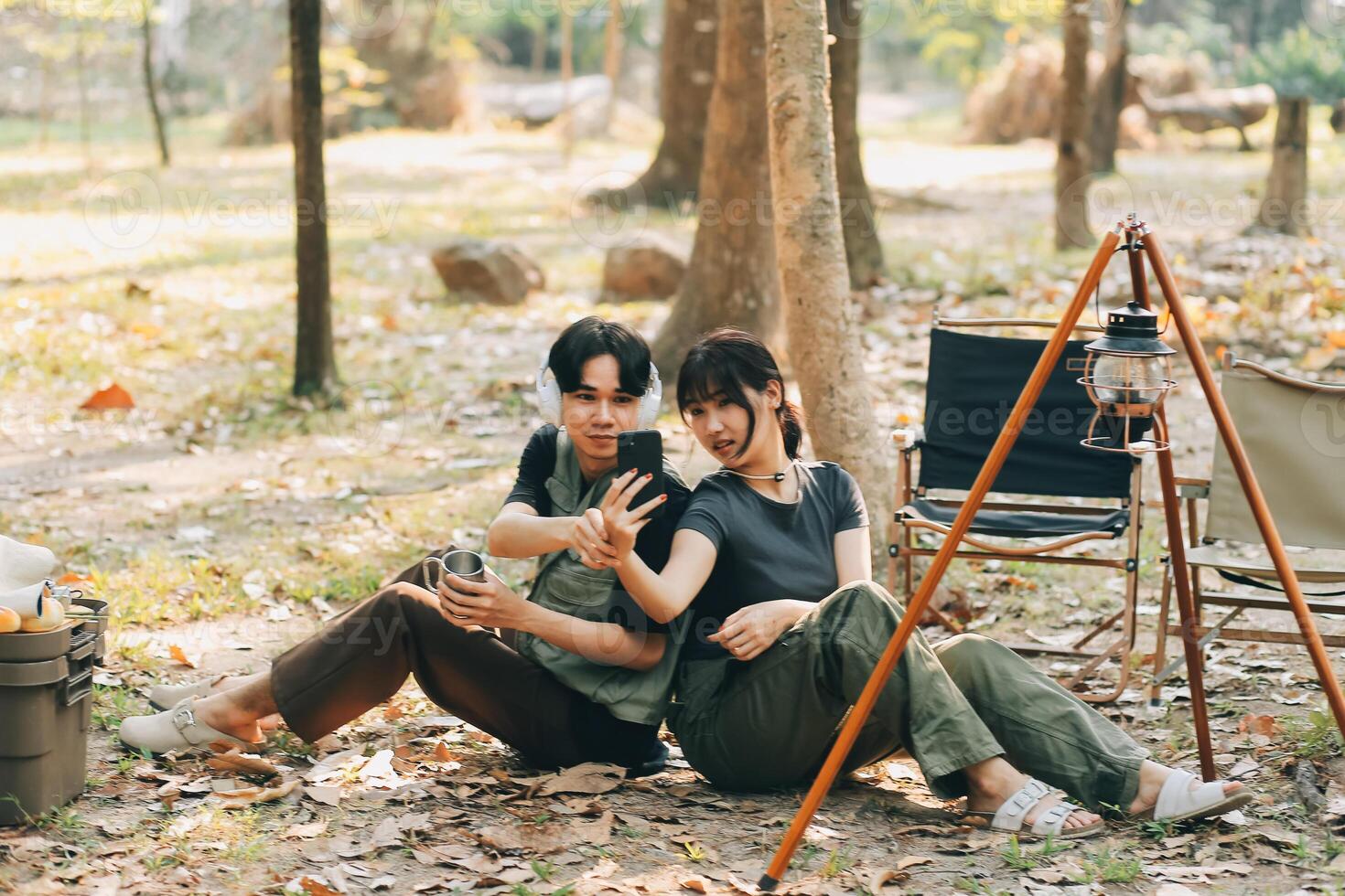 Asian couple sweet in tent inside on they camping trip, traveller relax and sleep togather in out door and camping trip photo