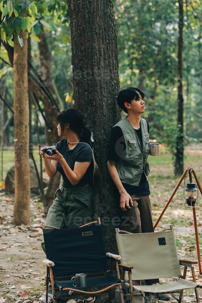 Asian couple sweet in tent inside on they camping trip, traveller relax and sleep togather in out door and camping trip photo