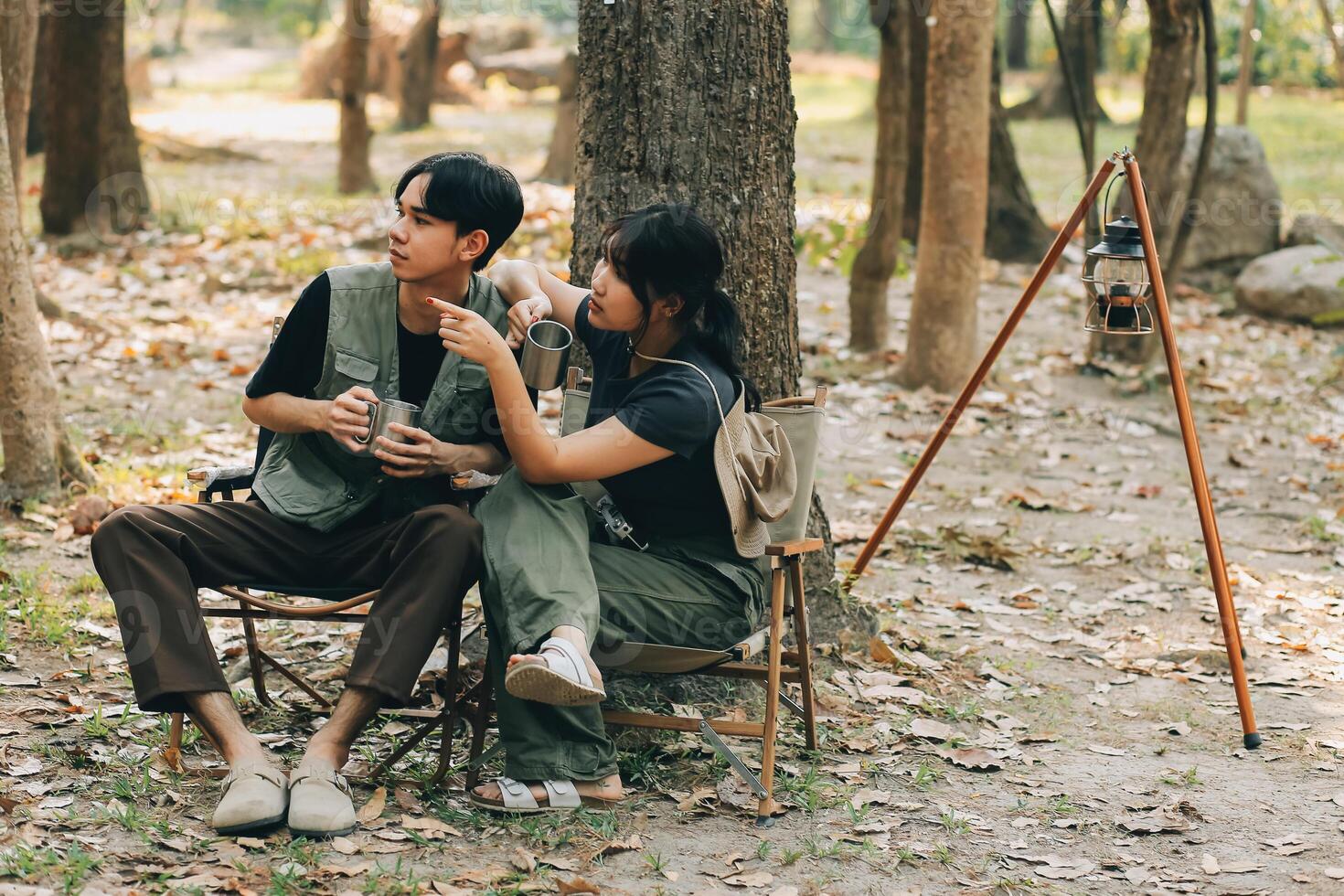 Asian couple sweet in tent inside on they camping trip, traveller relax and sleep togather in out door and camping trip photo