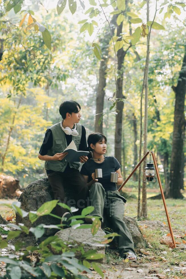 Asian couple sweet in tent inside on they camping trip, traveller relax and sleep togather in out door and camping trip photo