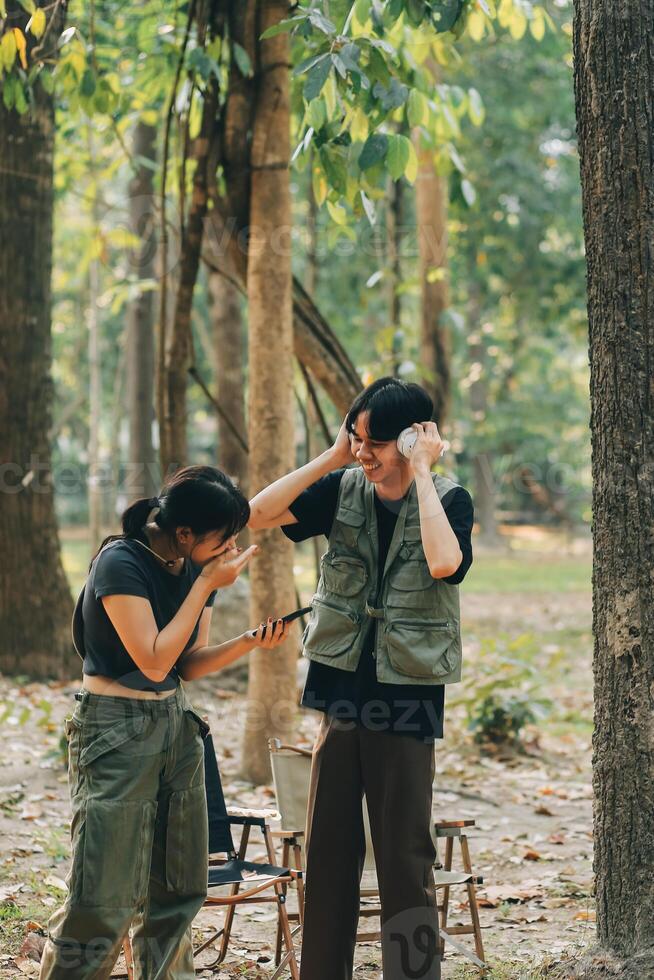 Asian couple sweet in tent inside on they camping trip, traveller relax and sleep togather in out door and camping trip photo