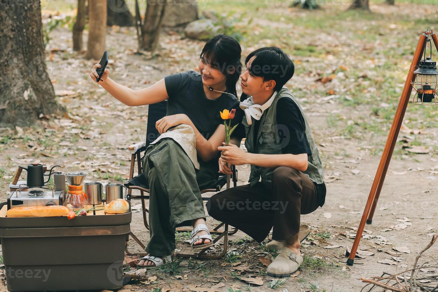 Asian couple sweet in tent inside on they camping trip, traveller relax and sleep togather in out door and camping trip photo