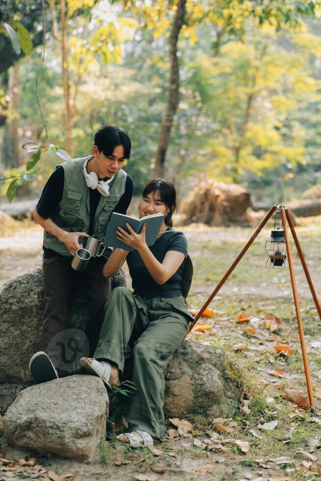 Asian couple sweet in tent inside on they camping trip, traveller relax and sleep togather in out door and camping trip photo