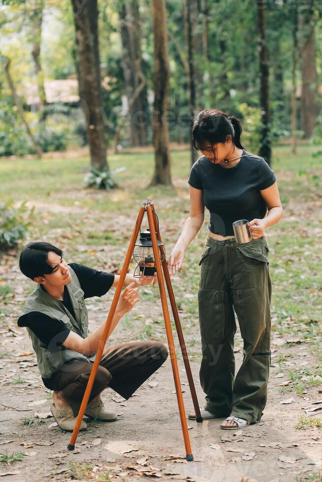 Asian couple sweet in tent inside on they camping trip, traveller relax and sleep togather in out door and camping trip photo