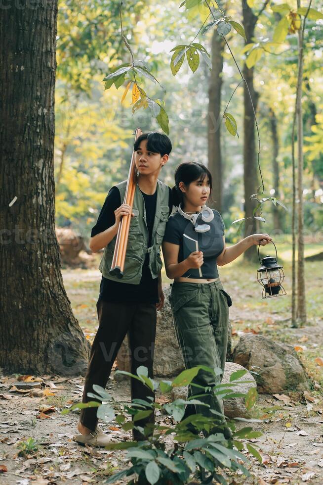 Asian couple sweet in tent inside on they camping trip, traveller relax and sleep togather in out door and camping trip photo