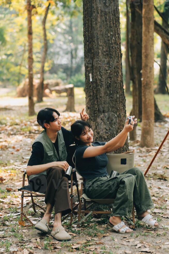 Asian couple sweet in tent inside on they camping trip, traveller relax and sleep togather in out door and camping trip photo