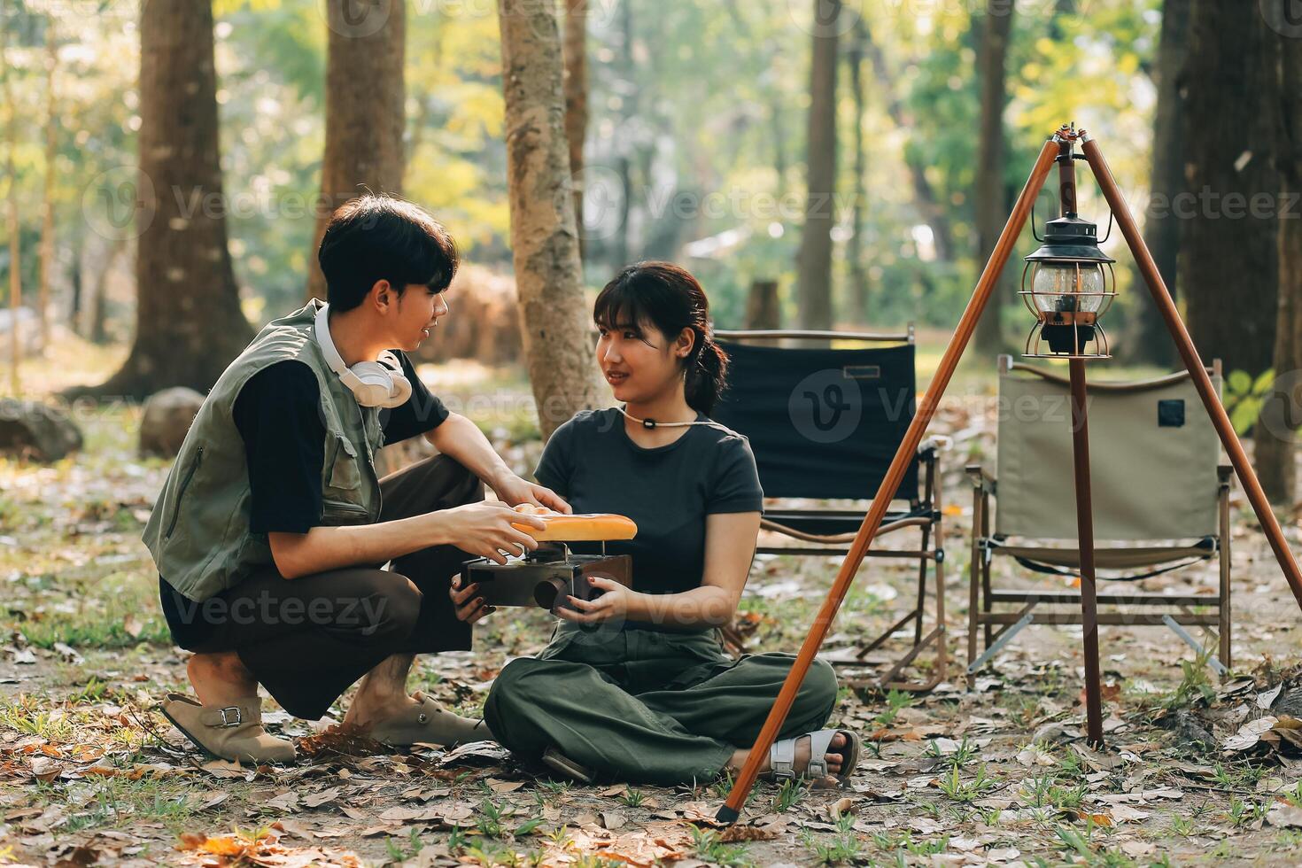 Asian couple sweet in tent inside on they camping trip, traveller relax and sleep togather in out door and camping trip photo
