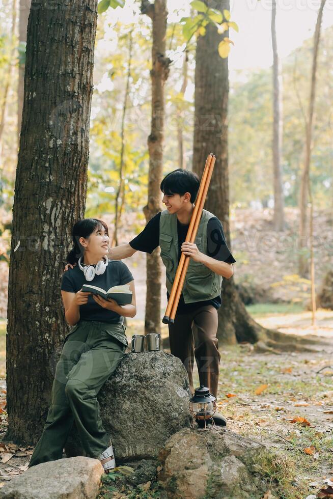 Asian couple sweet in tent inside on they camping trip, traveller relax and sleep togather in out door and camping trip photo