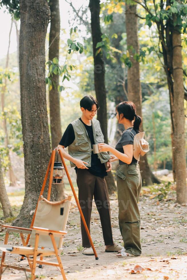 Asian couple sweet in tent inside on they camping trip, traveller relax and sleep togather in out door and camping trip photo