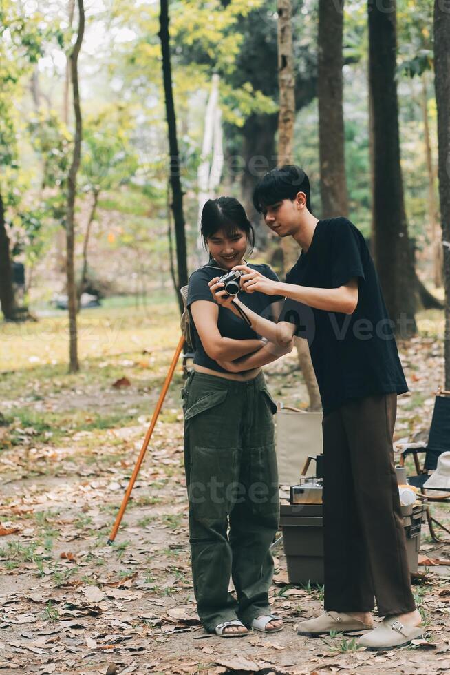 Asian couple sweet in tent inside on they camping trip, traveller relax and sleep togather in out door and camping trip photo
