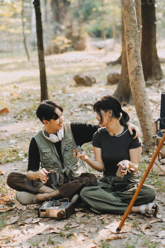 Asian couple sweet in tent inside on they camping trip, traveller relax and sleep togather in out door and camping trip photo