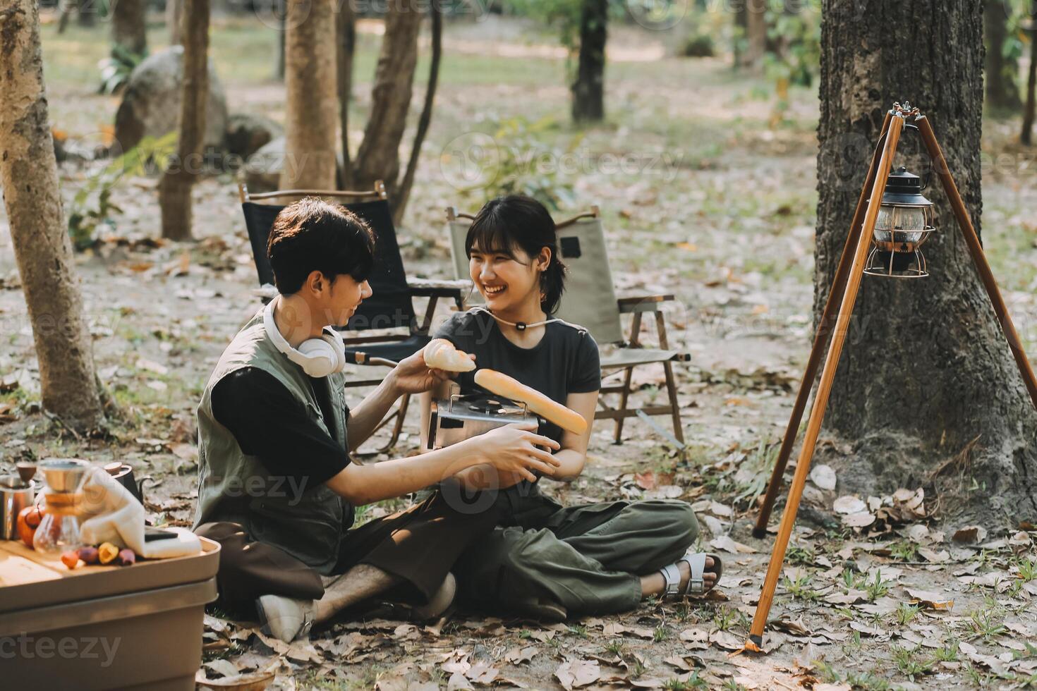 Asian couple sweet in tent inside on they camping trip, traveller relax and sleep togather in out door and camping trip photo
