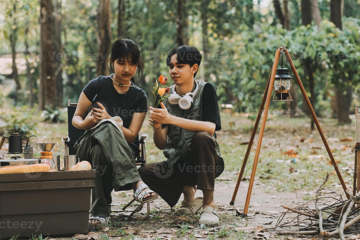 Asian couple sweet in tent inside on they camping trip, traveller relax and sleep togather in out door and camping trip photo
