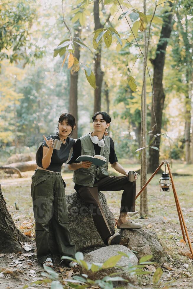 Asian couple sweet in tent inside on they camping trip, traveller relax and sleep togather in out door and camping trip photo