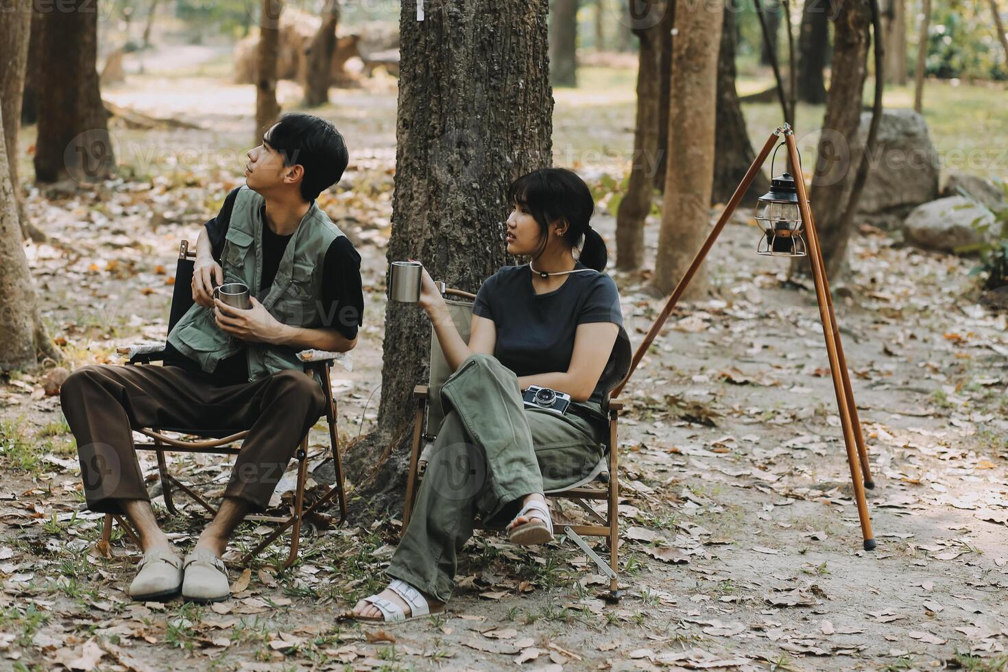 Asian couple sweet in tent inside on they camping trip, traveller relax and sleep togather in out door and camping trip photo