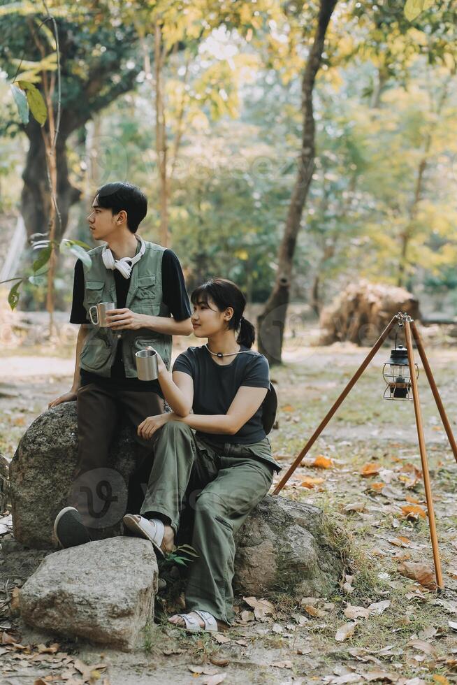 Asian couple sweet in tent inside on they camping trip, traveller relax and sleep togather in out door and camping trip photo