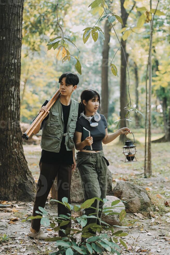 Asian couple sweet in tent inside on they camping trip, traveller relax and sleep togather in out door and camping trip photo