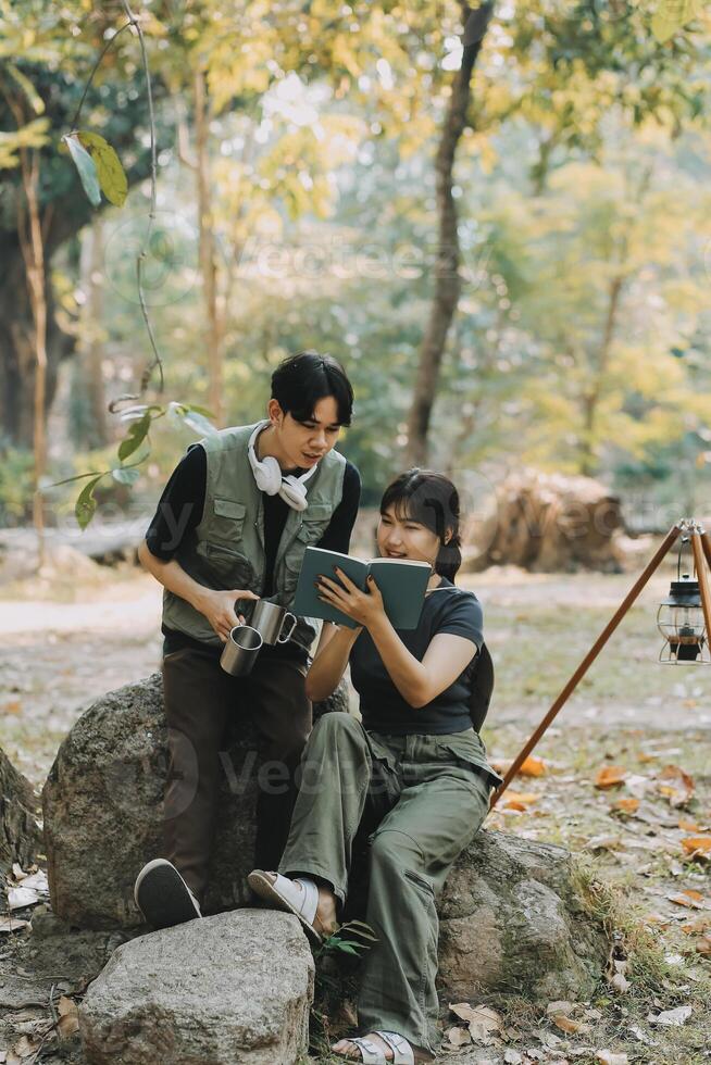 Asian couple sweet in tent inside on they camping trip, traveller relax and sleep togather in out door and camping trip photo